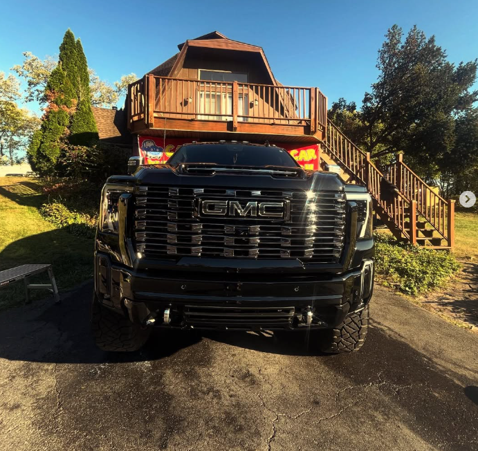 Glossy black GMC truck after professional exterior detailing